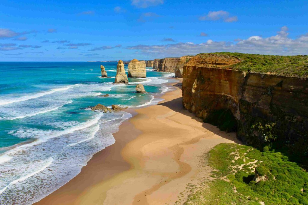 Breathtaking Melbourne beach in Australia with golden sands, turquoise waters, and a stunning coastal sunset—top travel destination for summer getaways, surfing, and relaxation in 2025.